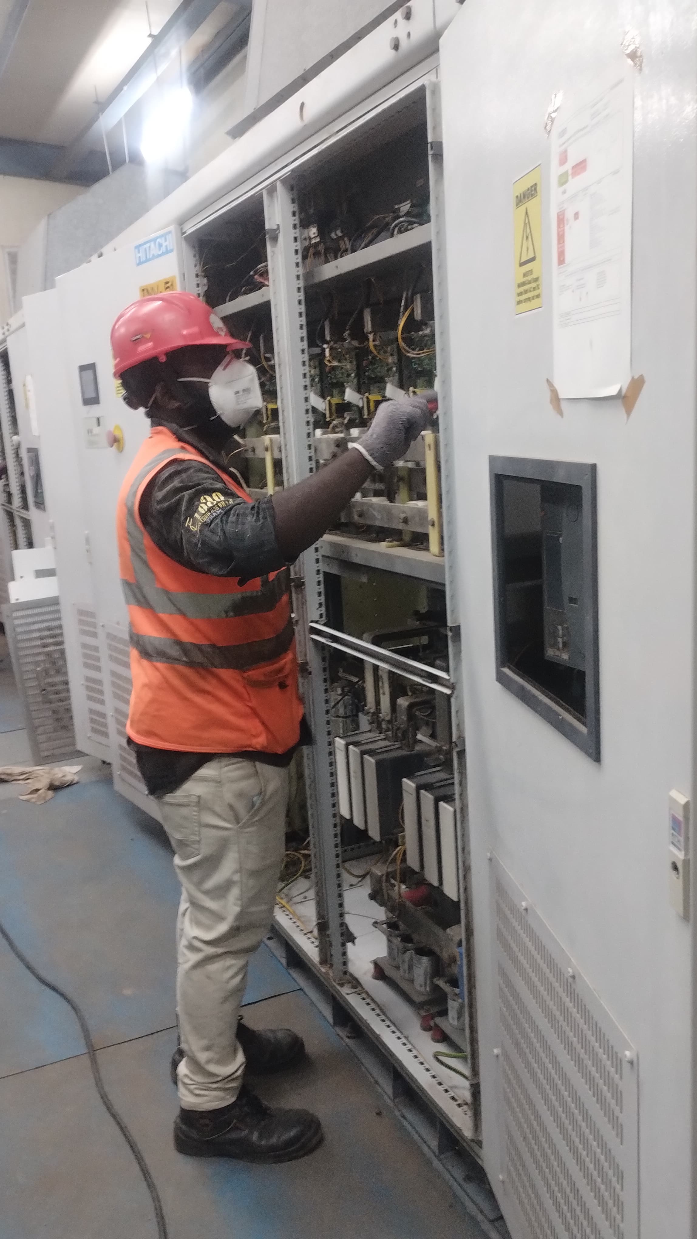 Maintenance work on Hitachi industrial electrical panel