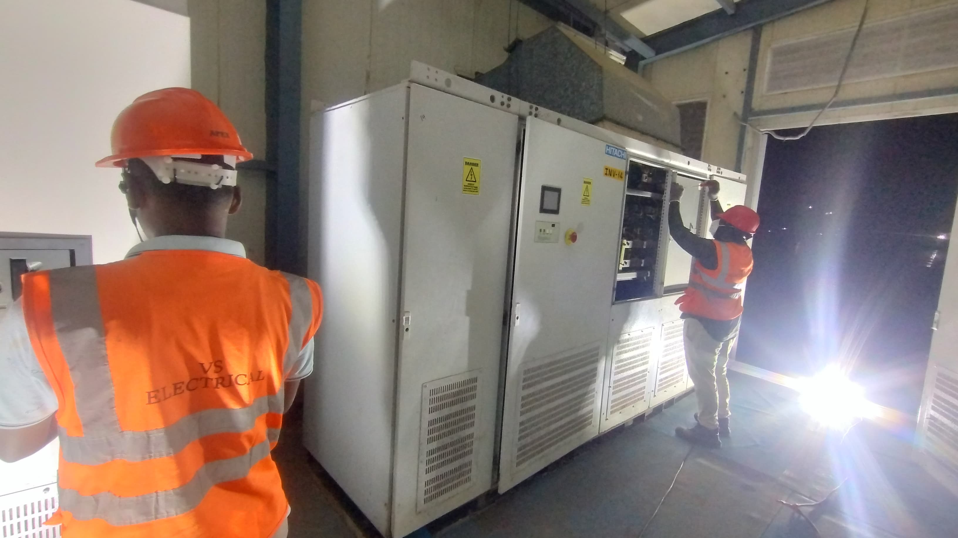 VS Electrical team working on large industrial electrical panel