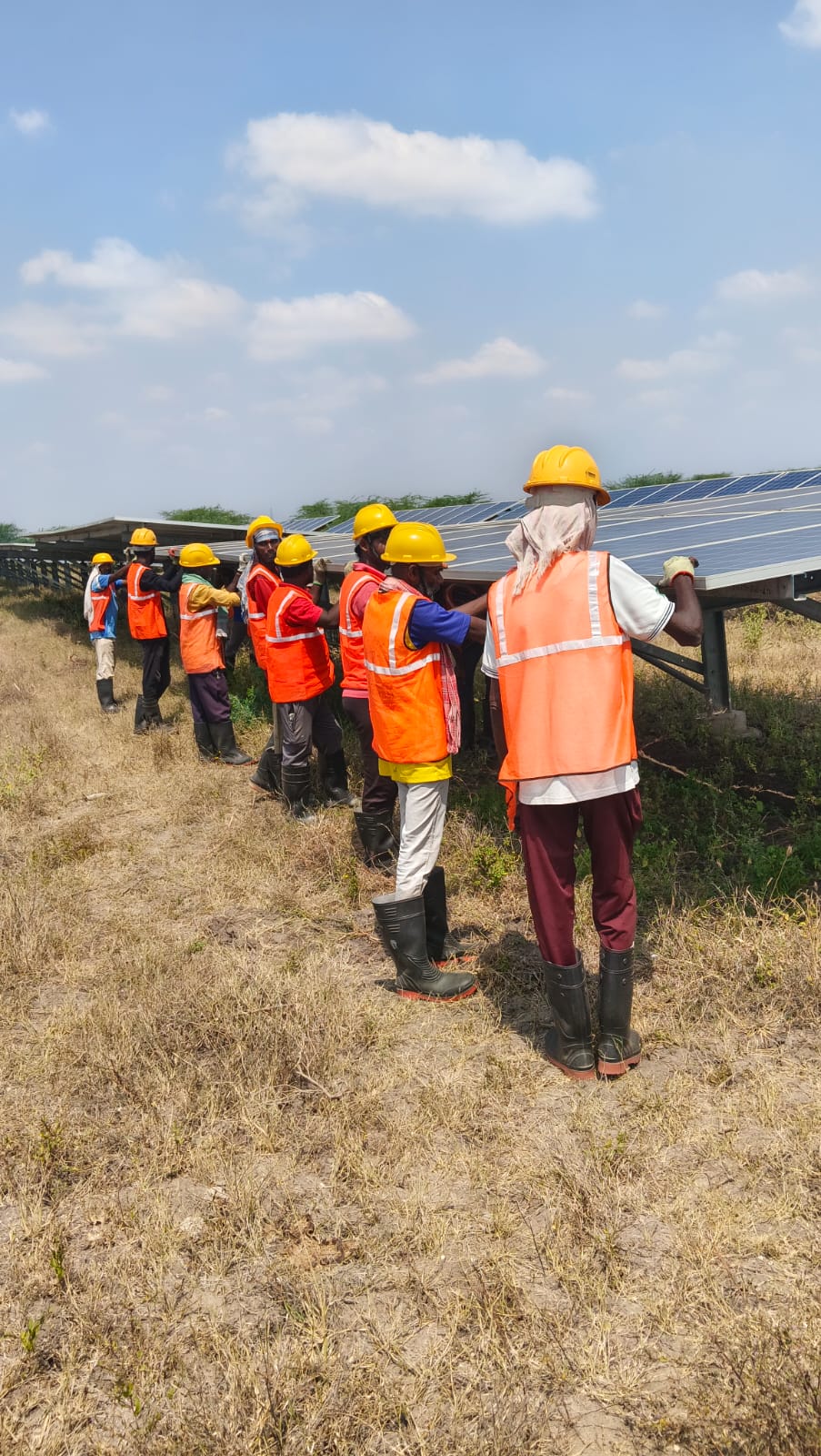 Team erecting solar panel array at ground mounted solar project