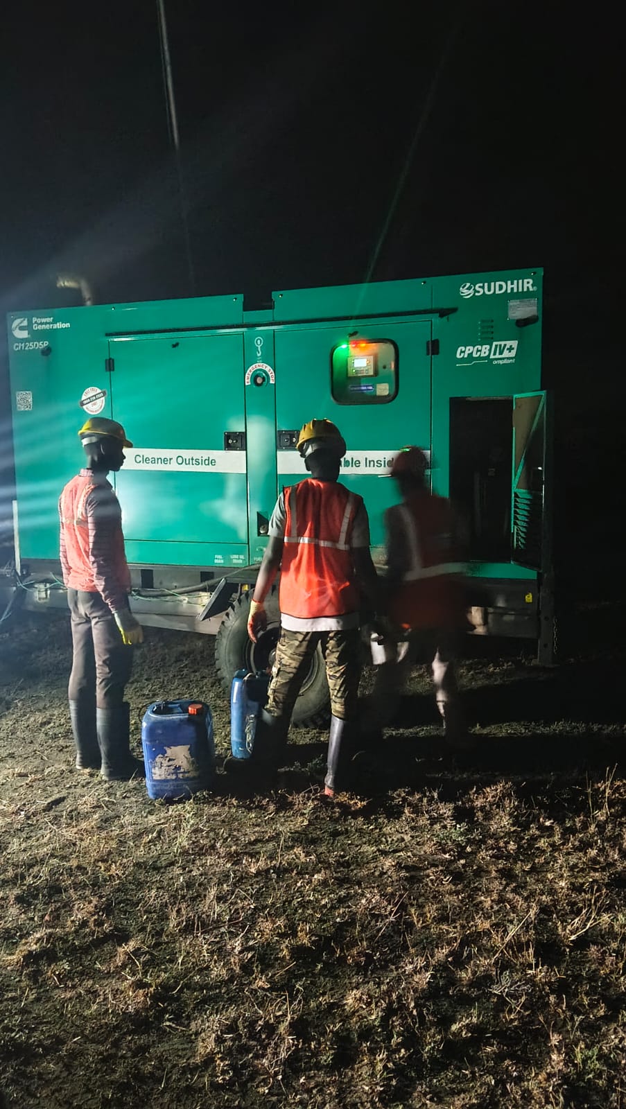 Field service team working on industrial generator at project site