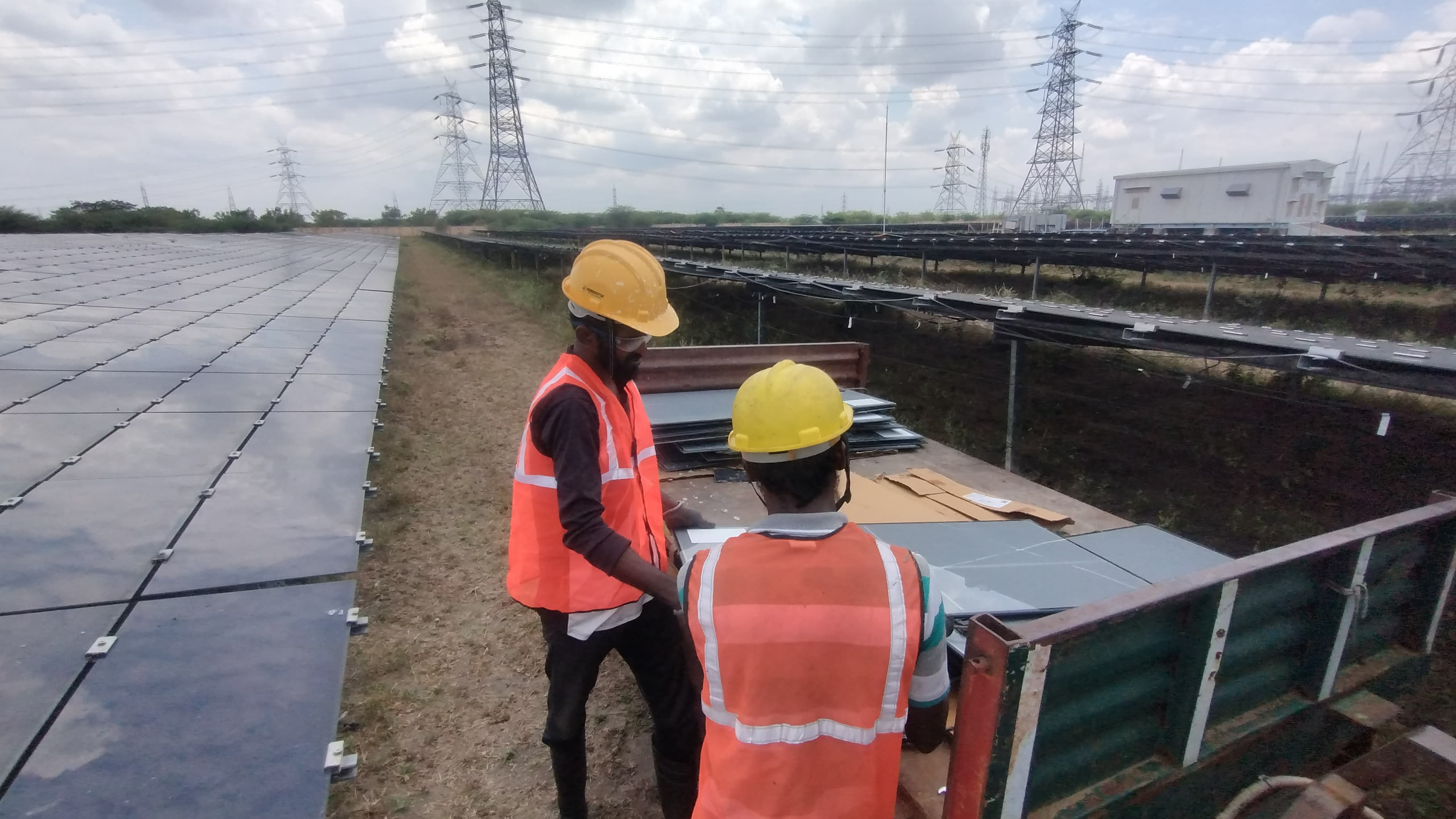 Workers installing solar panels at utility-scale solar power plant